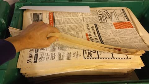 Open plastic crate containing copies of Loughborough Students Union Fast Forward publication.
