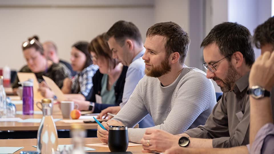 a group of people sitting at desks