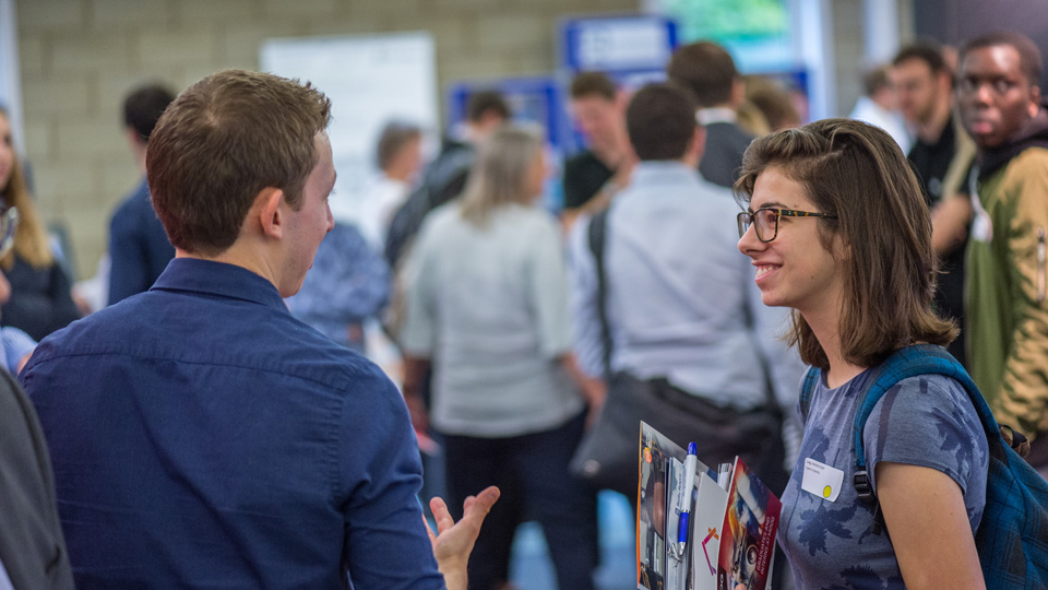 two people talking at an event