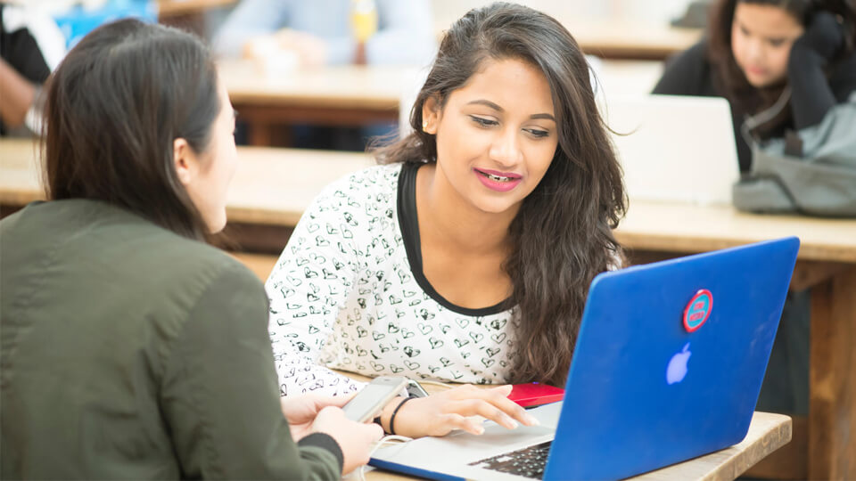 students looking at a laptop screen