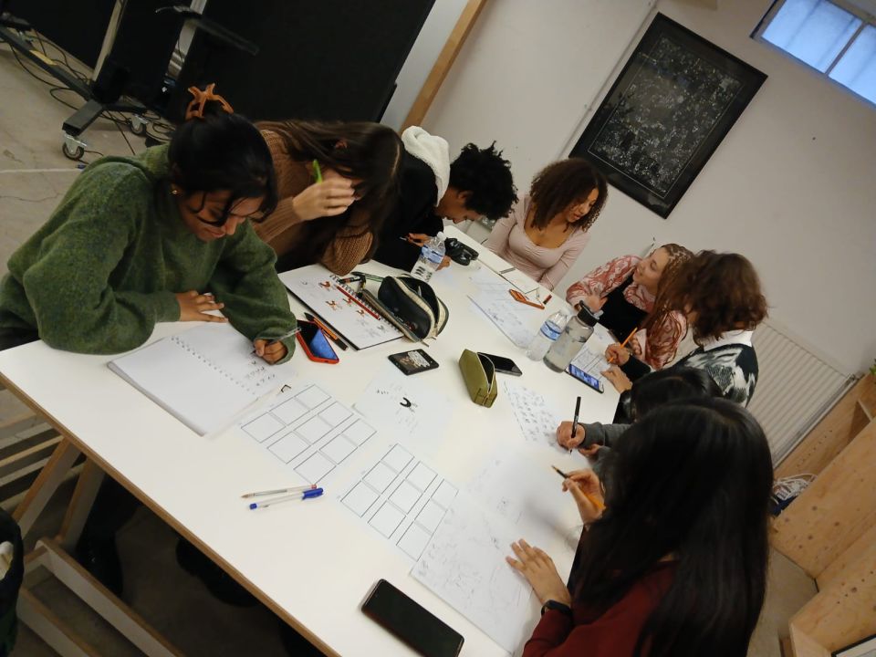 7 Students sat round a table, working together