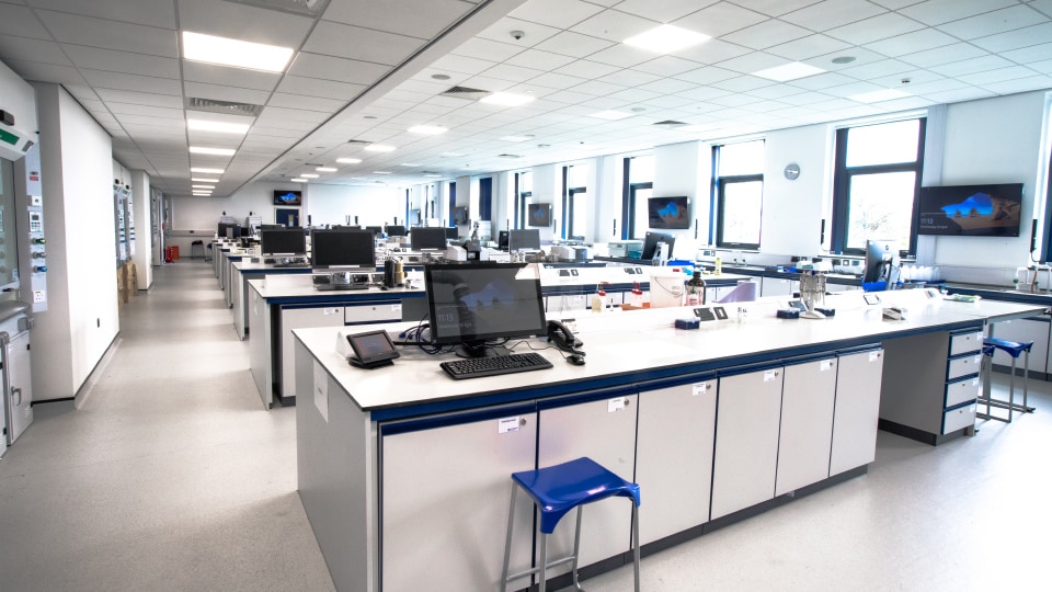West Park Labs WPL211 - Spacious, bright specialist lab with long workbenches, computers, stools, and equipment. Large windows provide natural light.