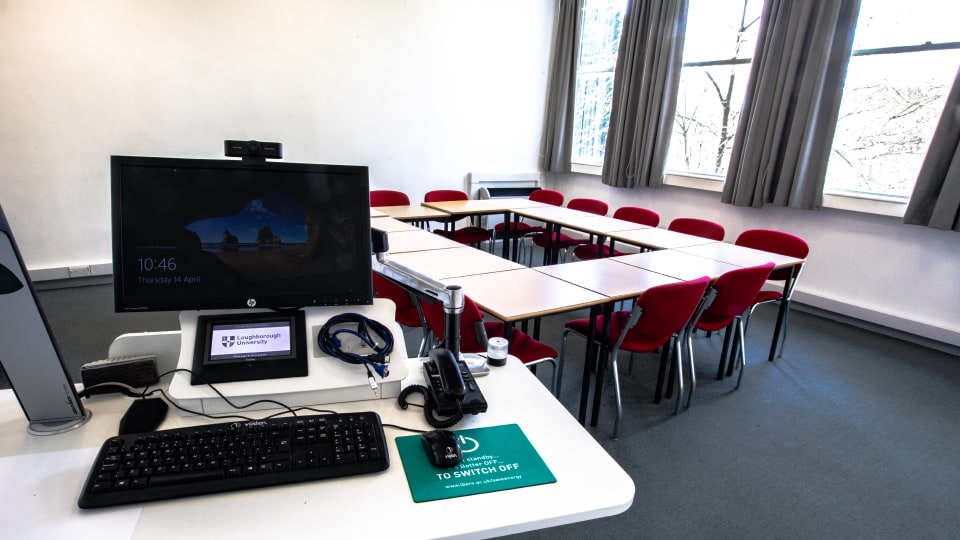 Edward Barnsley 63108 - Small teaching room with U-shaped table arrangement, red chairs, computer station, and large windows.