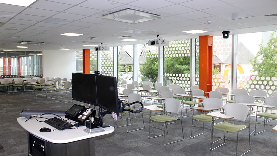 Airy, large-windowed teaching space with individual seat-desks for variety of layouts.