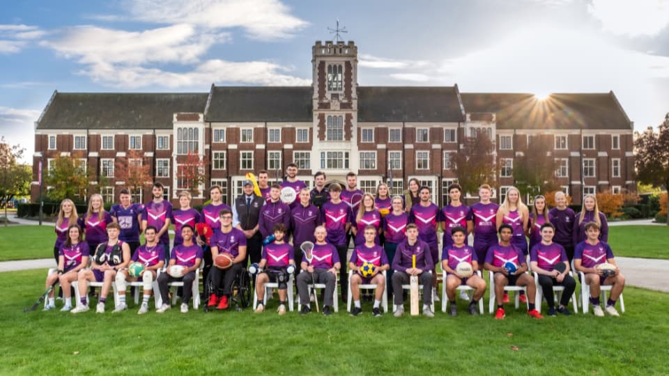 sports team in front of the campus