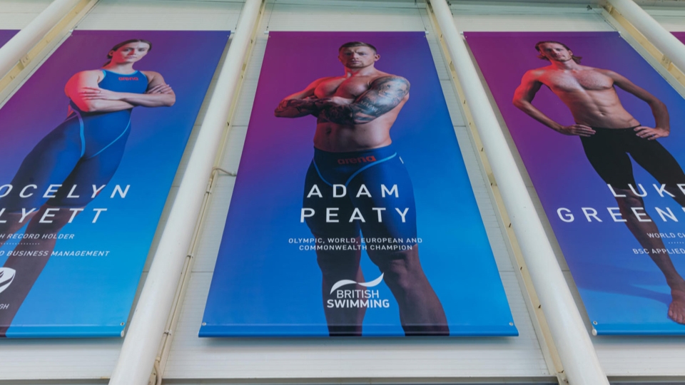 Three wall posters of Olympic swimmers