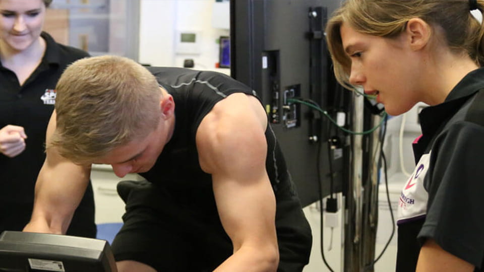 an athlete being monitored whilst using sport science equipment