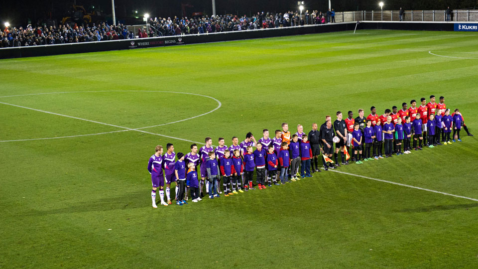 teams lined up on the centre line of the pitch