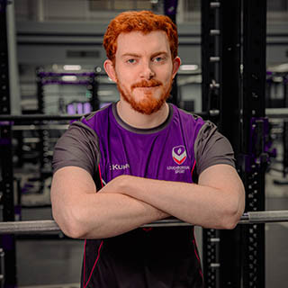 Luke is smiling for a headshot wearing Loughborough Sport kit