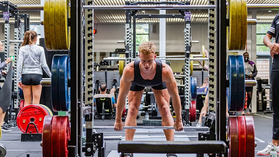 a man lifting weights in the gym