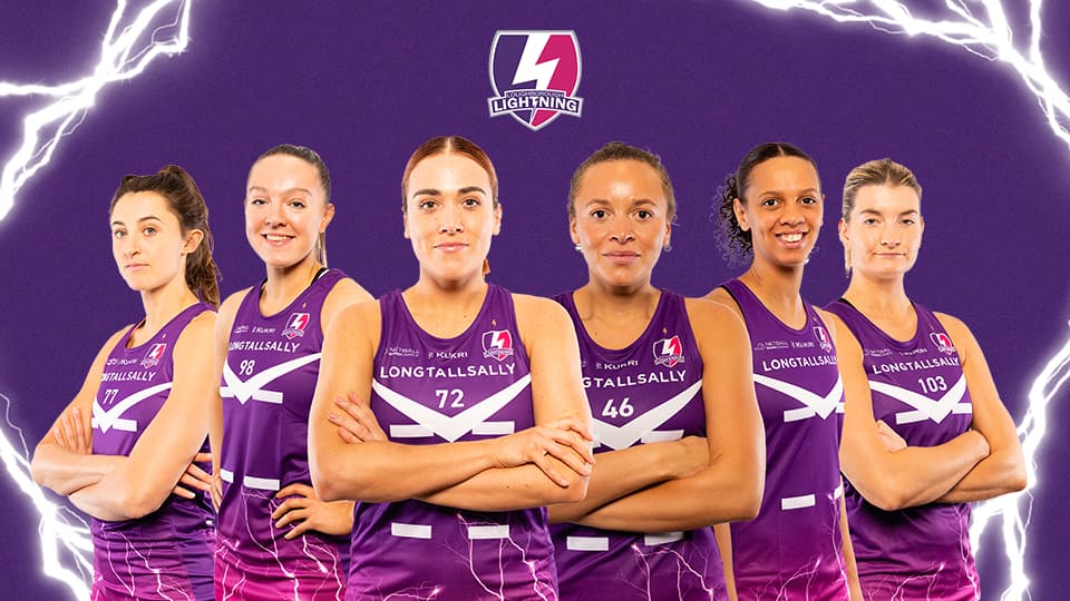 six netball players facing the camera
