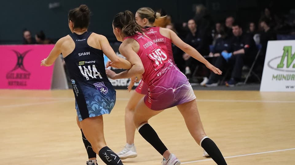 netball game, players shown from behind