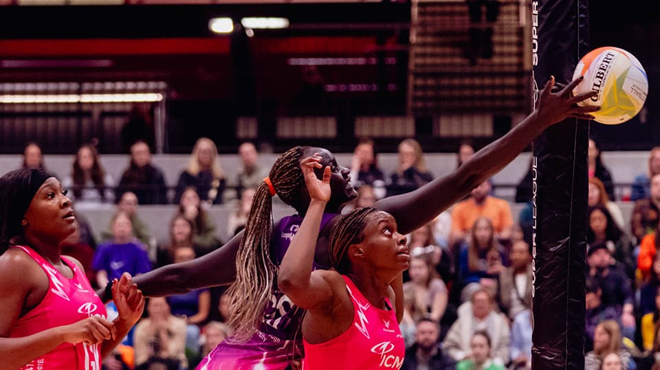 Mary Cholhok contesting for a netball against a Pulse defender