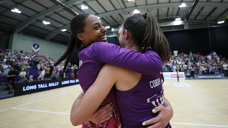 netball players in an embrace