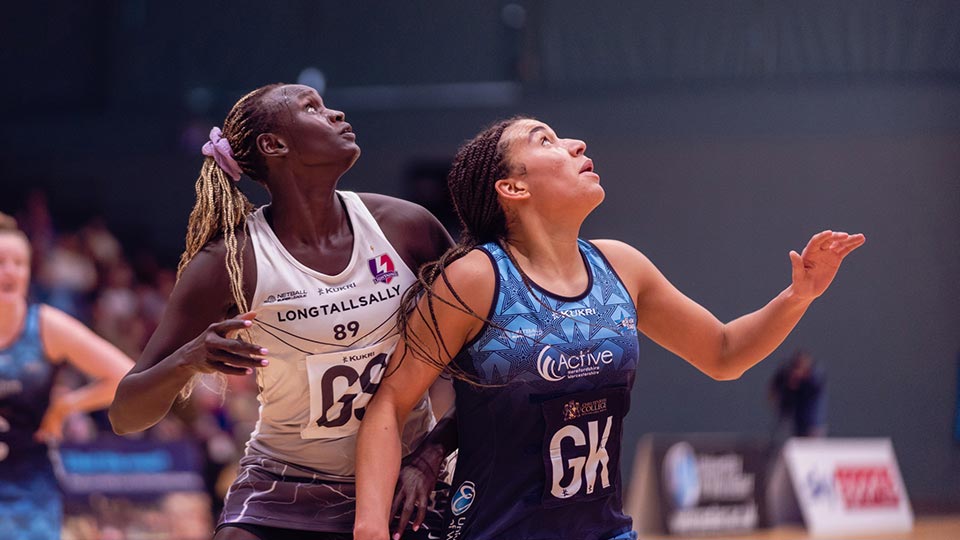 Two netball players on the court