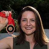 Goldie holding a medal