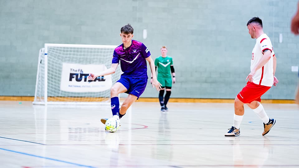 Loughborough Students Futsal player on court kicking a futsal
