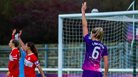 A Lightning football player standing on the pitch with back to the camera