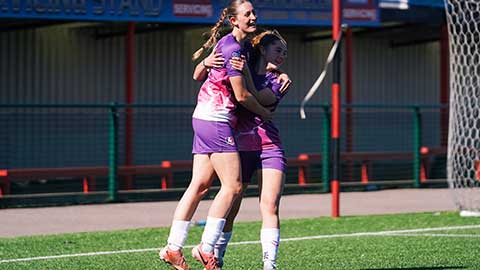 Players on a pitch embracing each other