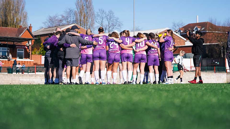 Loughborough Lightning football players mid game on the pitch