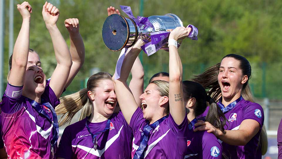 Loughborough Lightning Football players holding up a trophy
