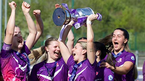 Loughborough Lightning Football players holding up a trophy