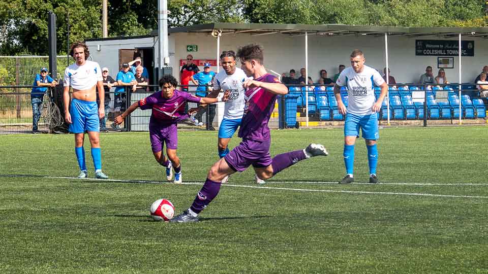 LSFC player Josh Strouts, striking a football on a football pitch