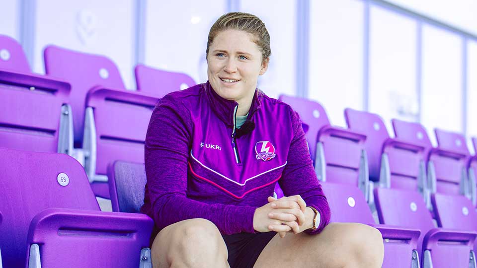 Charlotte Steggle sitting, looking directly at the camera smiling