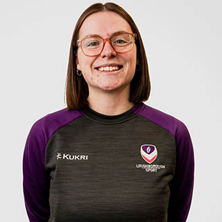 Hannah is wearing a Loughborough Sport jumper and is smiling for a headshot.