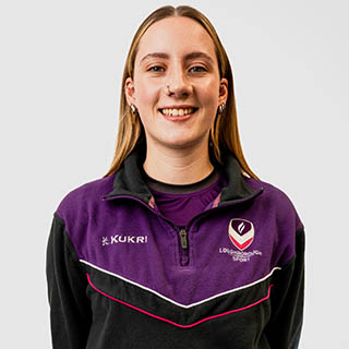 Thea is wearing a Loughborough Sport jumper and is smiling for a headshot.