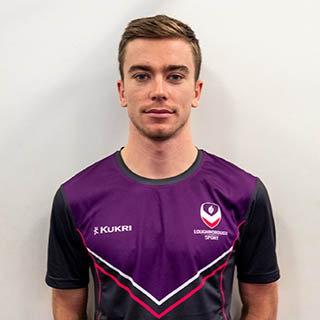 Arthur is smiling for a photo wearing a Loughborough Sport top.