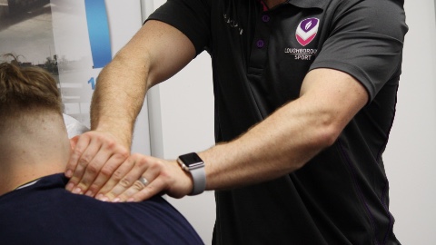 close up of a physiotherapist's hands massaging a person's neck