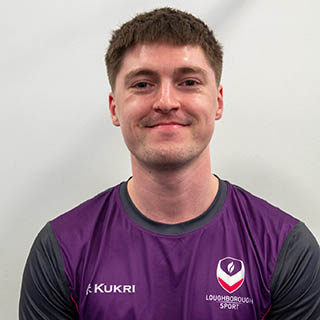 Joe is smiling for a photo wearing a Loughborough Sport top.