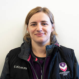 Yasmin is smiling for a headshot.