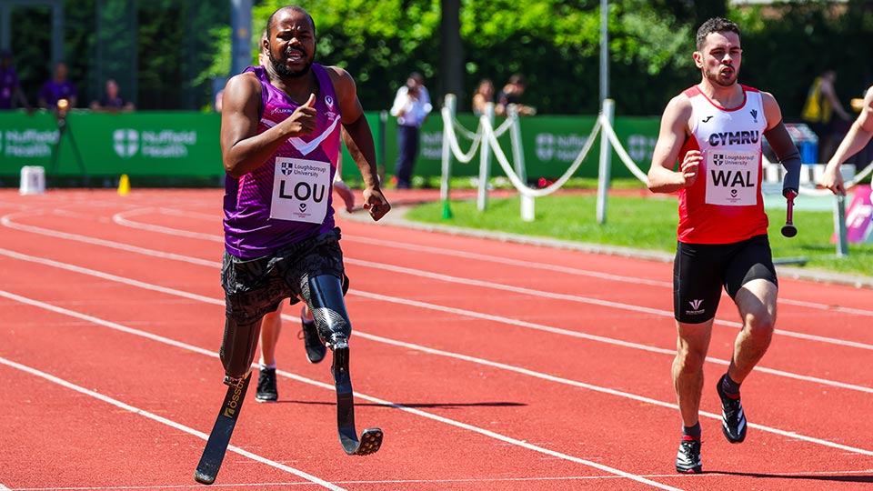 A Loughborough University para athlete running on blades in a race