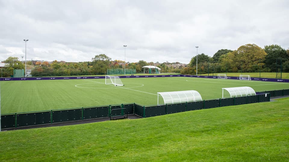 an empty football pitch with green grass