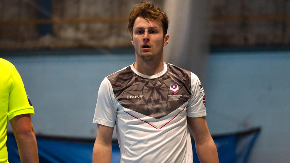 Jan is wearing a grey away playing jersey for Loughborough Futsal.