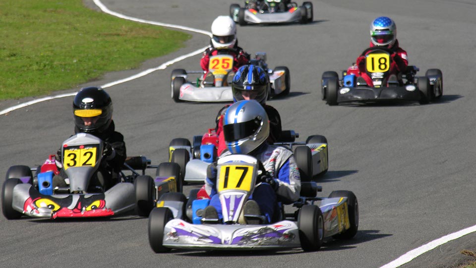 three karts racing on a track