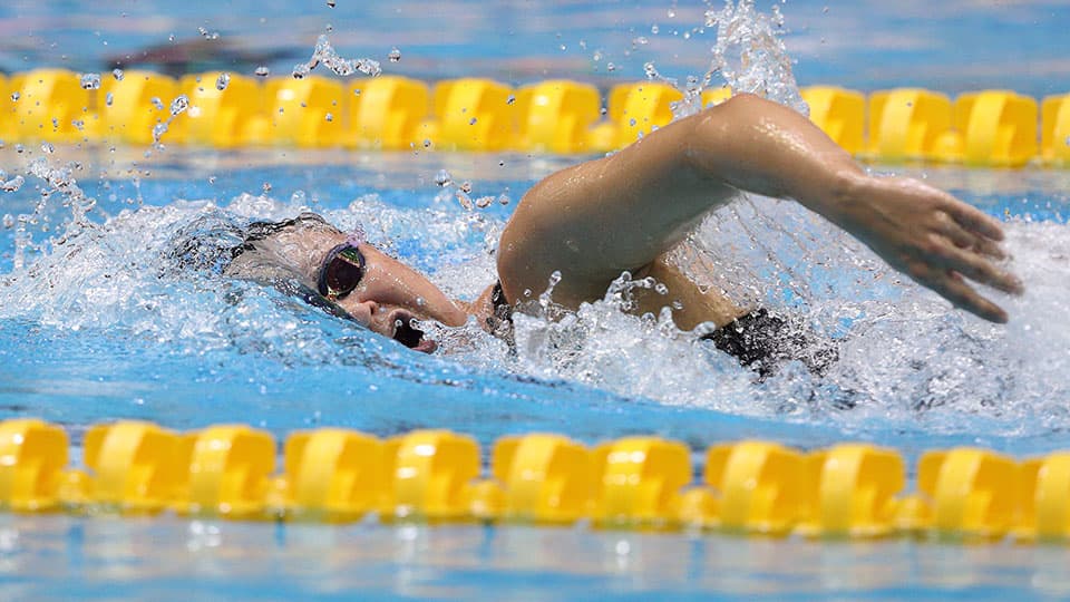 a person swimming in a lane in a swimming pool