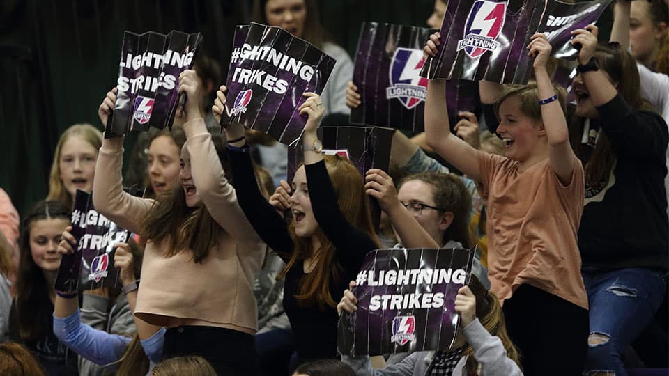 fans holding up signs with text 'Lightning strikes'