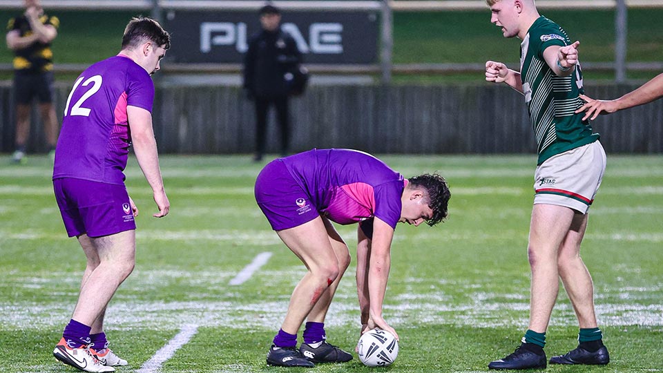 Loughborough rugby league players on the pitch and one is about to pick up the ball