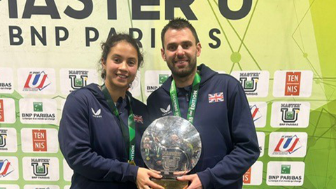 eliz maloney and tom kisiel holding the championship trophy