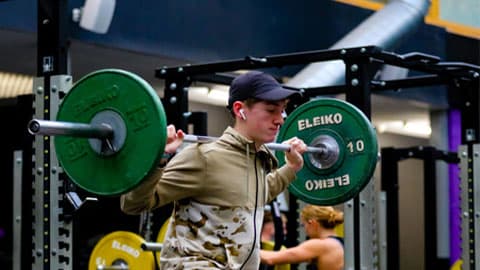 a man about to lift weights in the gym