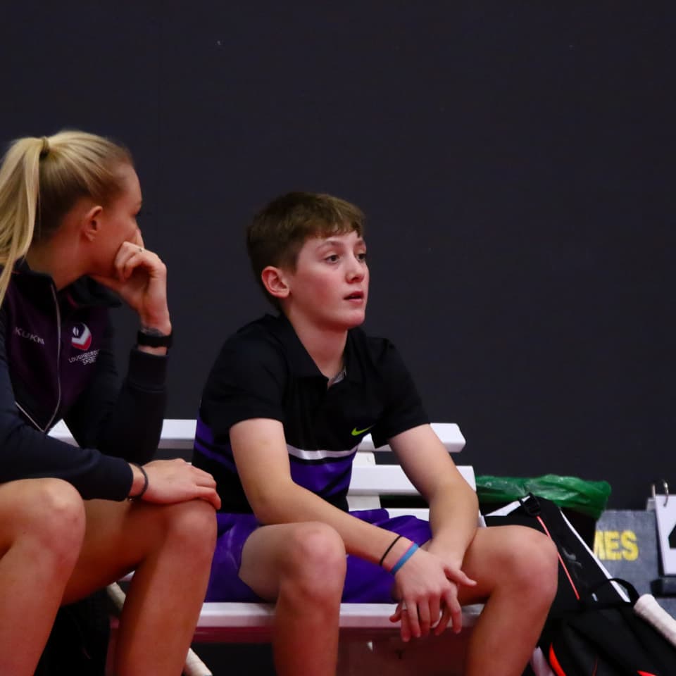 a woman and a child watching the game