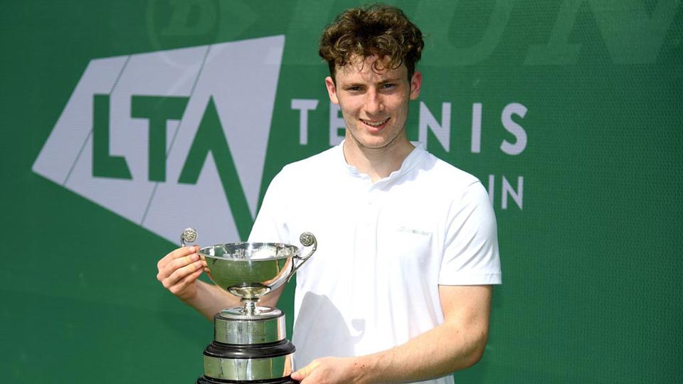 Luca holding a tennis trophy