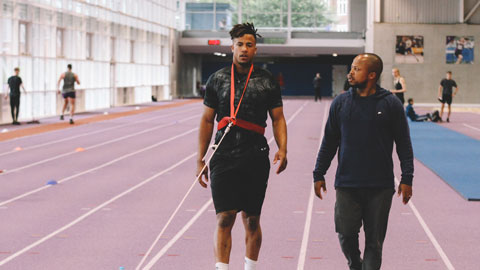 two men on an indoor running track