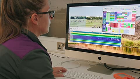 a woman looking at a computer monitor
