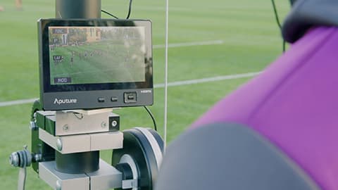 a person watching a pitch side monitor