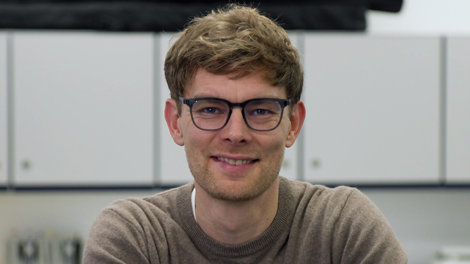 Christof wearing glasses looking directly at the camera