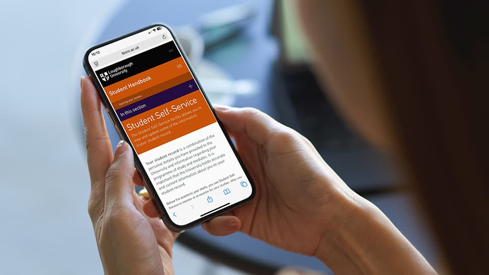 Student looking at the Self-service page of the Student Handbook.